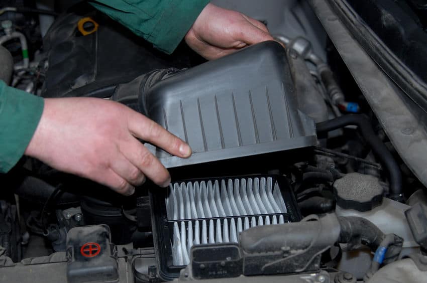Man chaing the air filter in a car