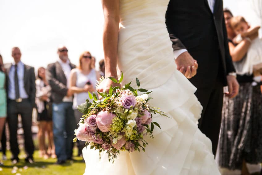Flowers being held by bride during wedding